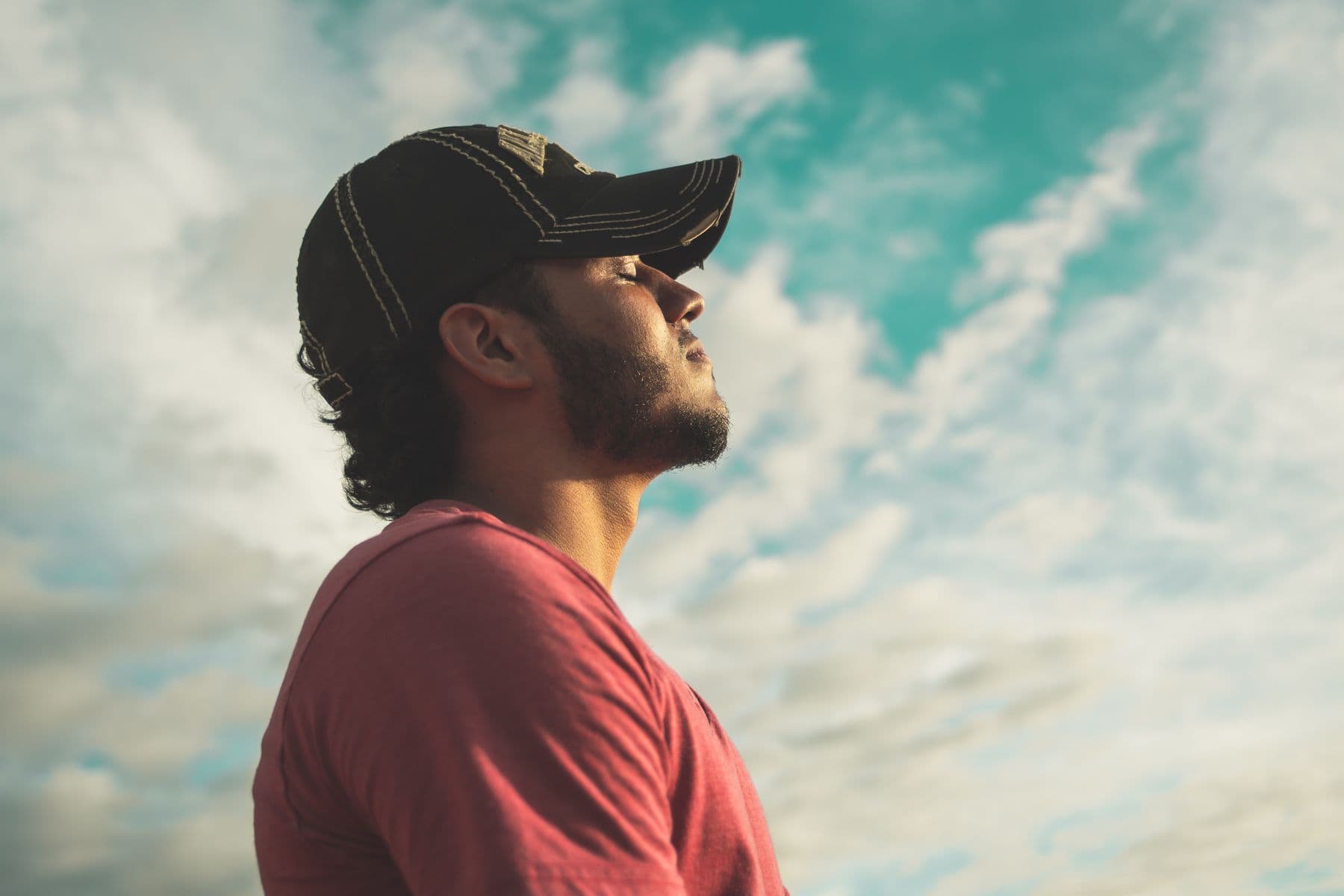 Man looking up at the sky, pausing to steady himself