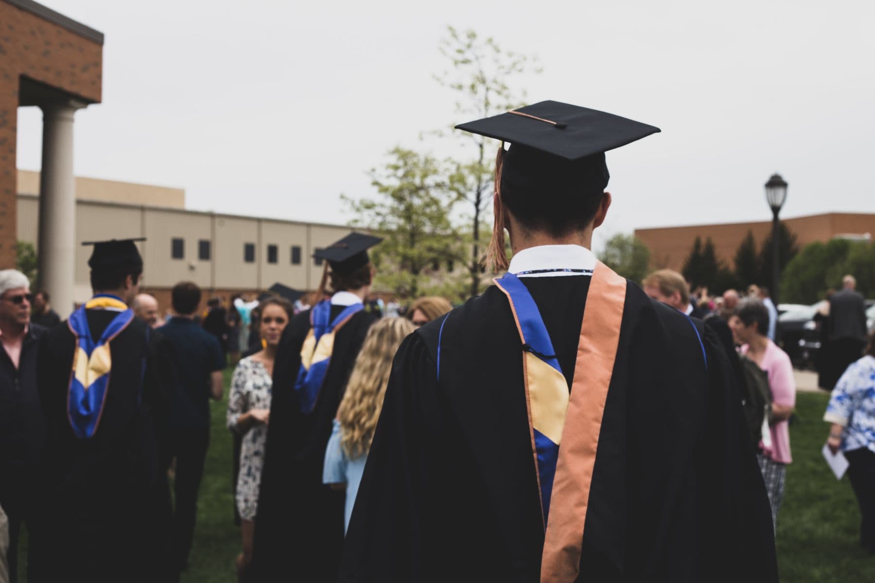 Graduates in caps and gowns celebrating together