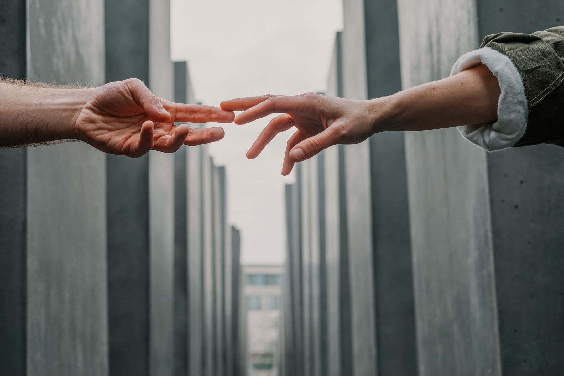 Two hands reaching toward each other, a symbol of connection
